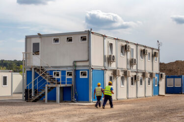 Workers at mobile containers and cabins base for the site manager and employees.