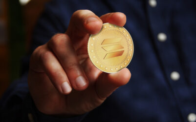 Solana altcoin cryptocurrency symbol golden coin in hand abstract concept.
